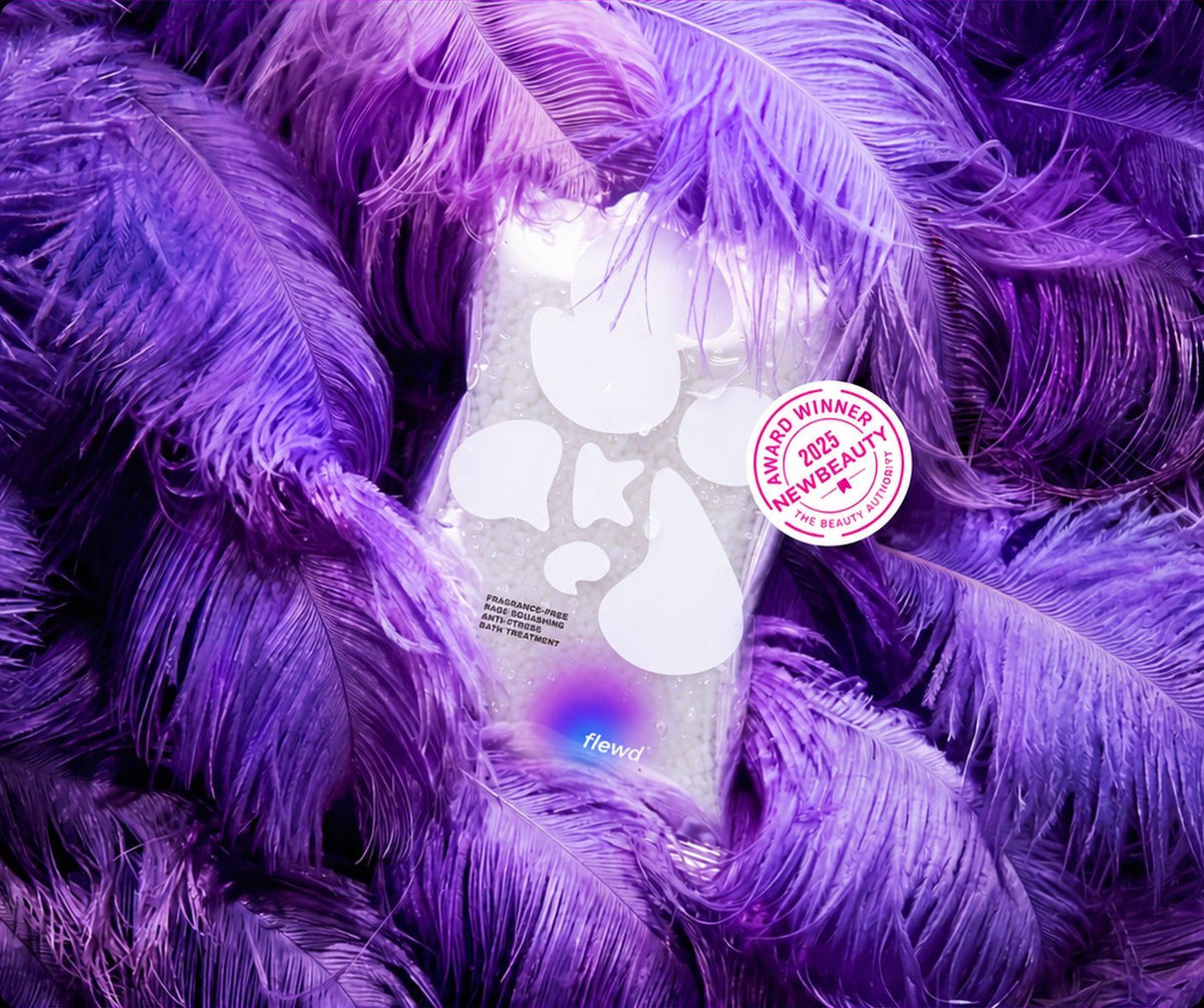 Flewd fragrance-free Rage Squashing stresscare bath soak clear pouch in purple feathers with a NewBeauty award badge