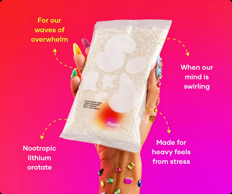 Flewd fragrance-free Sads Smashing bath soak clear pouch held in a hand with jeweled nails, for overwhelmed days