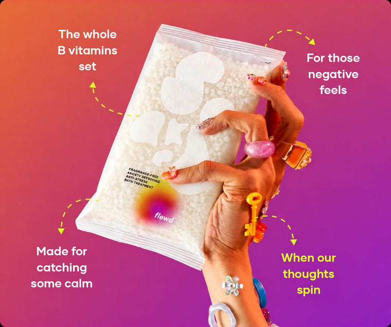 Fragrance-free Anxiety Destroying pouch in a hand with colorful rings, part of the Flewd Stresscare Trio