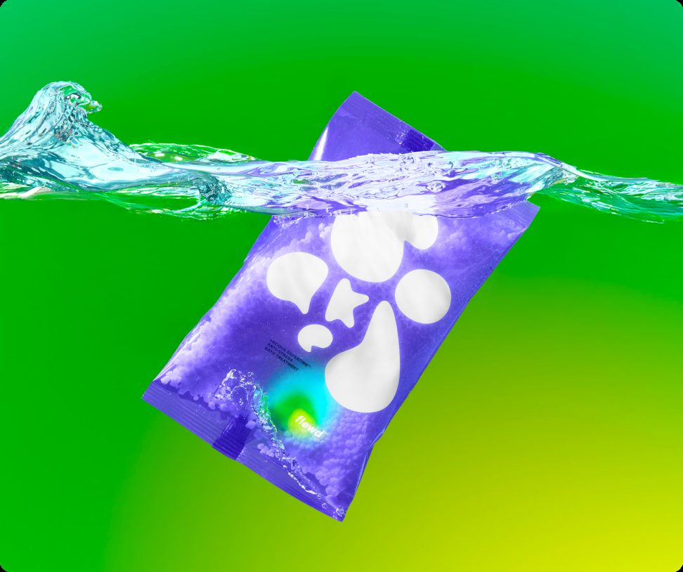 Flewd Fatigue Defeating magnesium bath soak pouch splashing into water on a green background