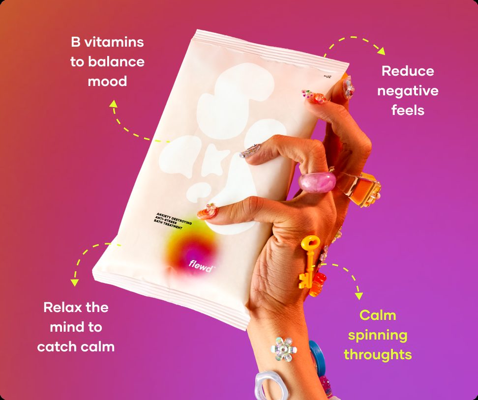 Flewd Anxiety Destroying bath soak pouch held in a hand with colorful rings, for racing-thoughts nights