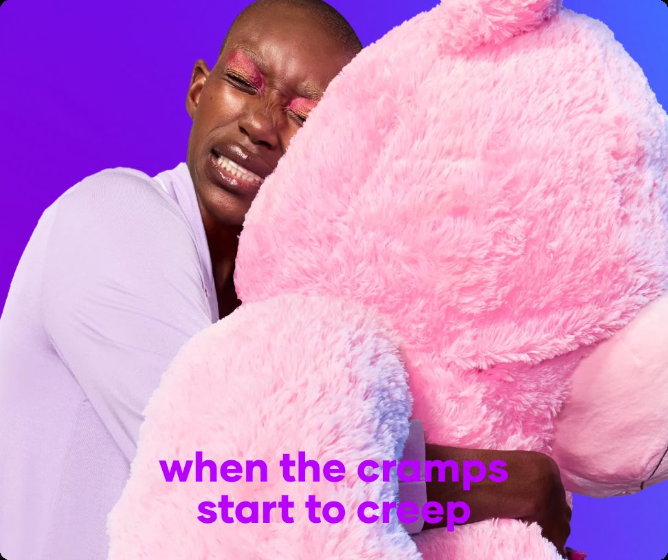 Person hugging a giant pink teddy bear on a cramp day