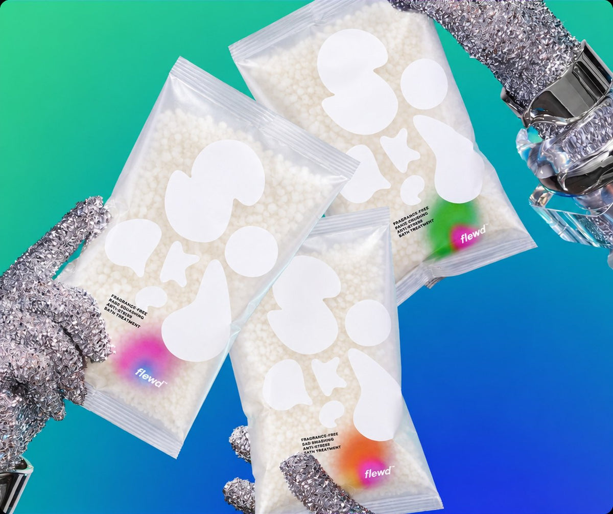 Flewd fragrance-free Nootropic Trio: three nootropic bath soak pouches held by glittery gloves