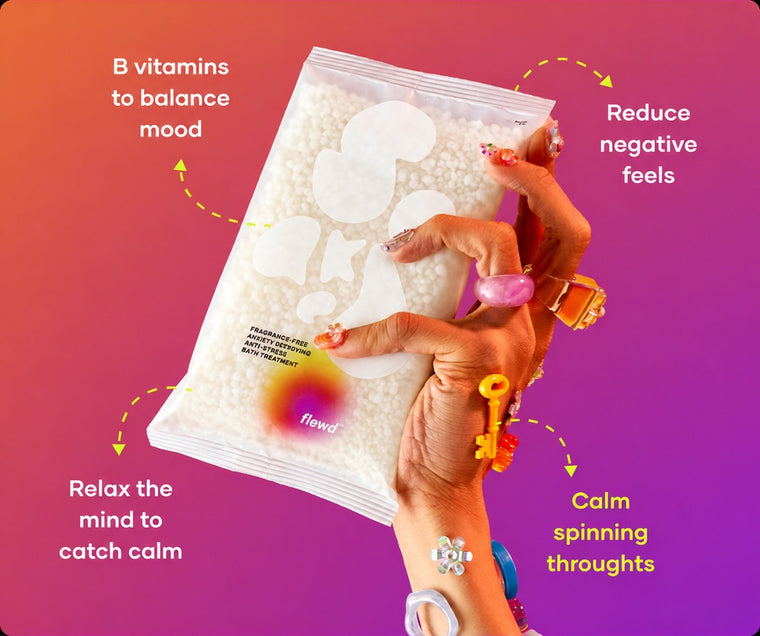 Fragrance-free Anxiety Destroying pouch in a hand with colorful rings, part of the Flewd Stresscare Trio