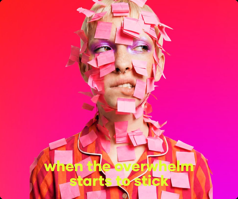 Woman with pink sticky notes covering her face on an overwhelmed day