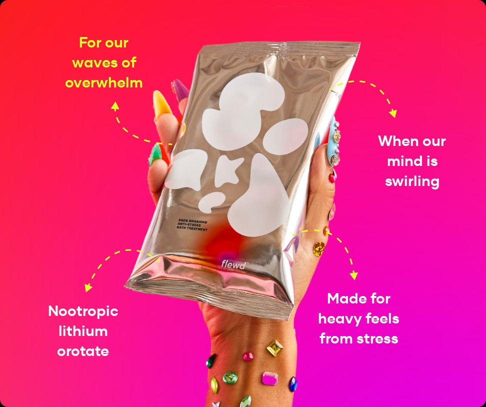 Flewd Sads Smashing bath soak pouch held in a hand with jeweled nails, for overwhelmed days