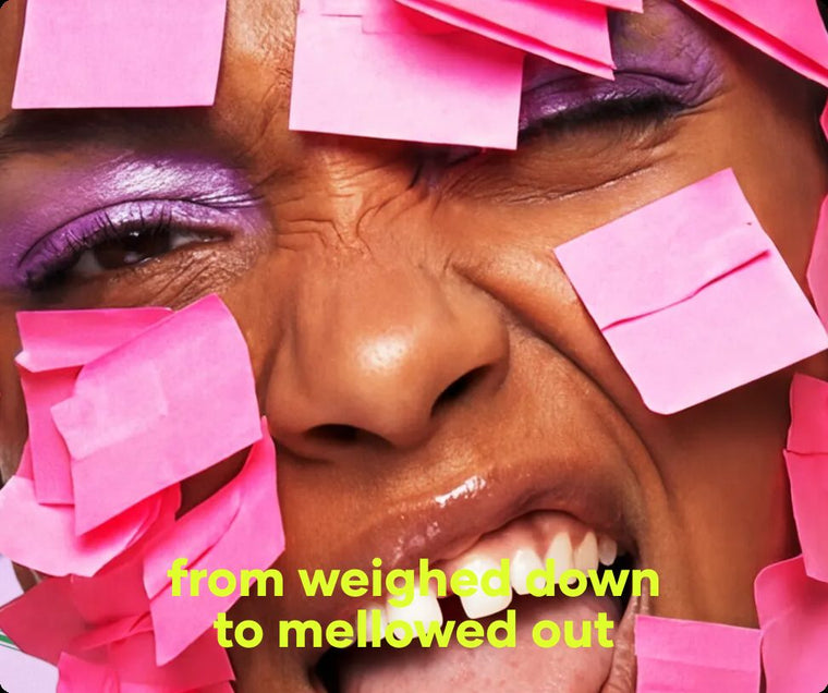 Smiling face half covered in pink sticky notes